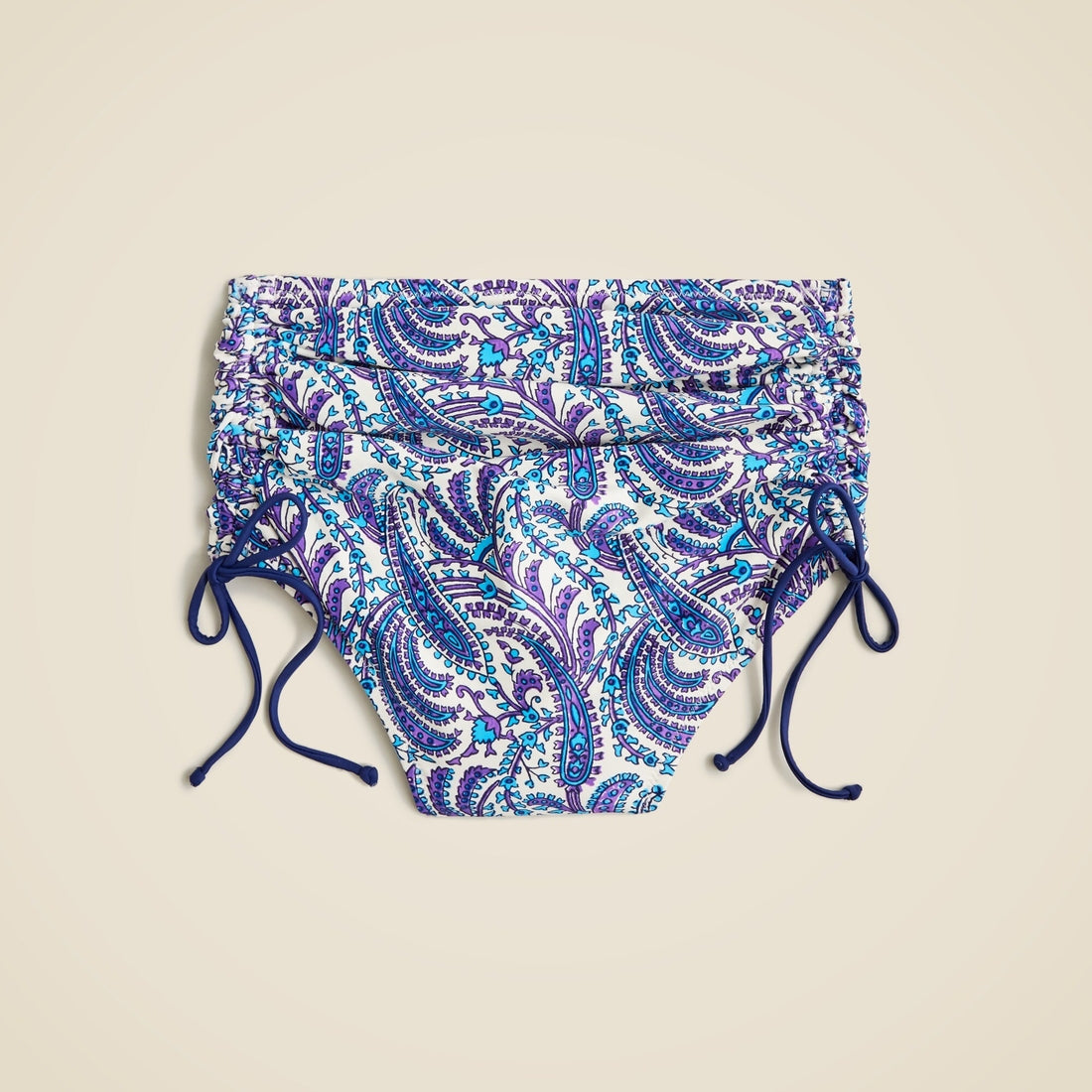 Ruched high-rise bikini bottom with adjustable side ties in purple paisley