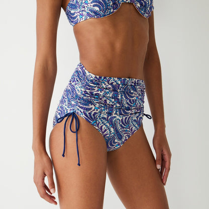 Ruched high-rise bikini bottom with adjustable side ties in purple paisley